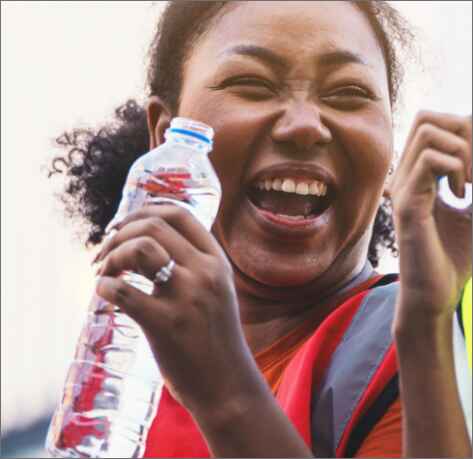 a woman holding a bottle of water