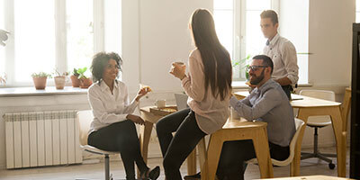 Co-workers in the table having a coffee break